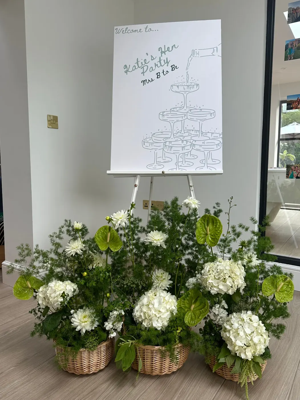 Studio Lo floral arrangements beside a celebration sign